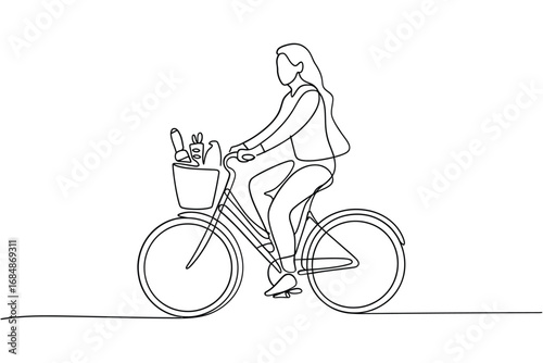 Woman riding a bicycle with a basket full of flowers