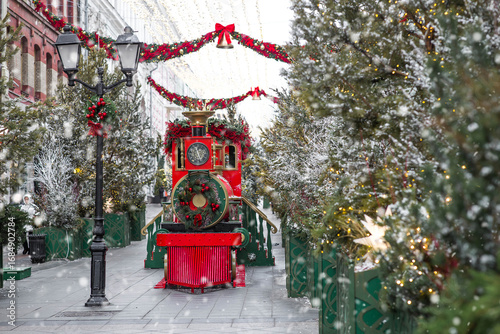 Christmas train in Moscow. Christmas postcard 2026. Beautiful New Year background with a train. Concept of preparing decorations and decor for the New Year.