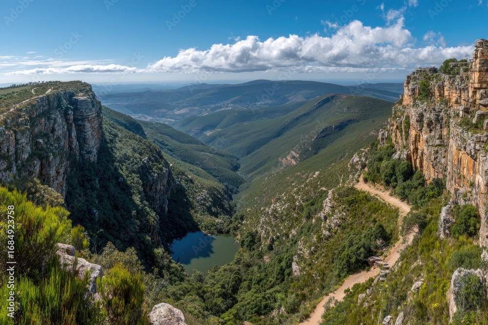 Naklejka premium High angle view of a mountain valley with a winding trail.