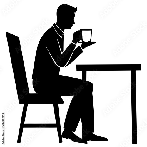 Man drinking coffee at desk silhouette