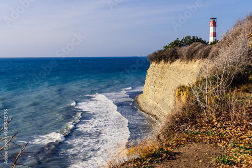 Lighthouse of Gelendzhik, Black Sea. A rocky shoreline with a Gelendzhik Lighthouse in the distance