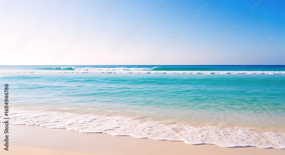 Fototapeta premium A Clear Turquoise Ocean Gently Laps At A Pristine Sandy Beach Under A Bright Blue Sky, Evoking Serenity And Tropical Relaxation.