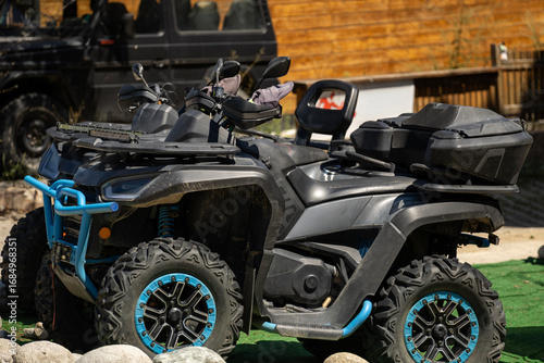 Bilde på lerret Two sleek, dark ATVs with bright blue accents