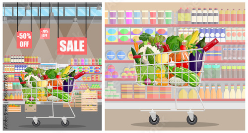 Shopping cart full of fresh fruit and vegetable inside a grocery store. Supermarket interior background for healthy food concept.