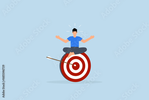 Stay focused and concentrate on business objective, calm entrepreneur contemplates while seated and concentrating on large archery bullseye