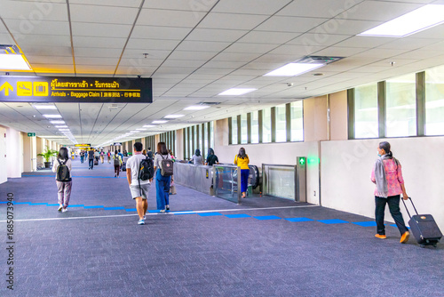 Walking through the airport terminal in Bangkok Thailand.