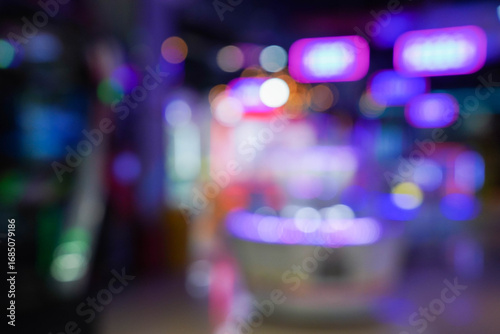 Defocused view of amusement Arcade game center. Toy crane game vending machine