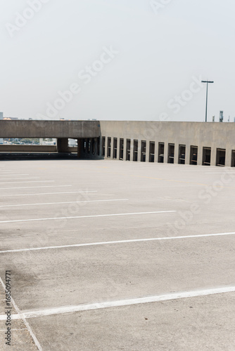 Open rooftop parking deck with empty spaces.
