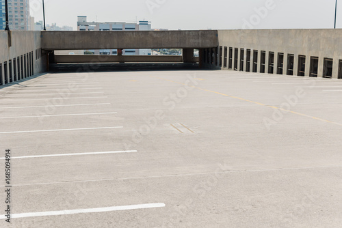Open rooftop parking deck with empty spaces.