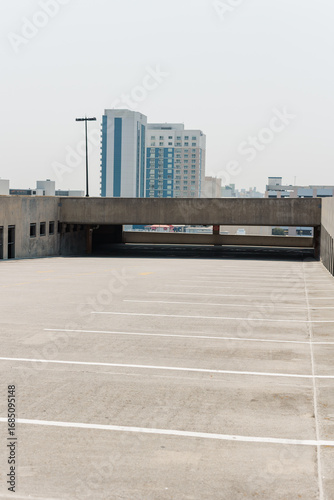 Open rooftop parking deck with empty spaces.