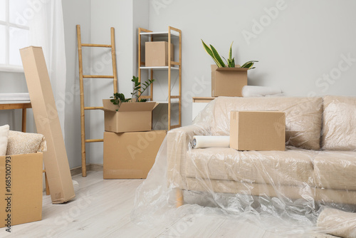 Sofa with film and boxes in...