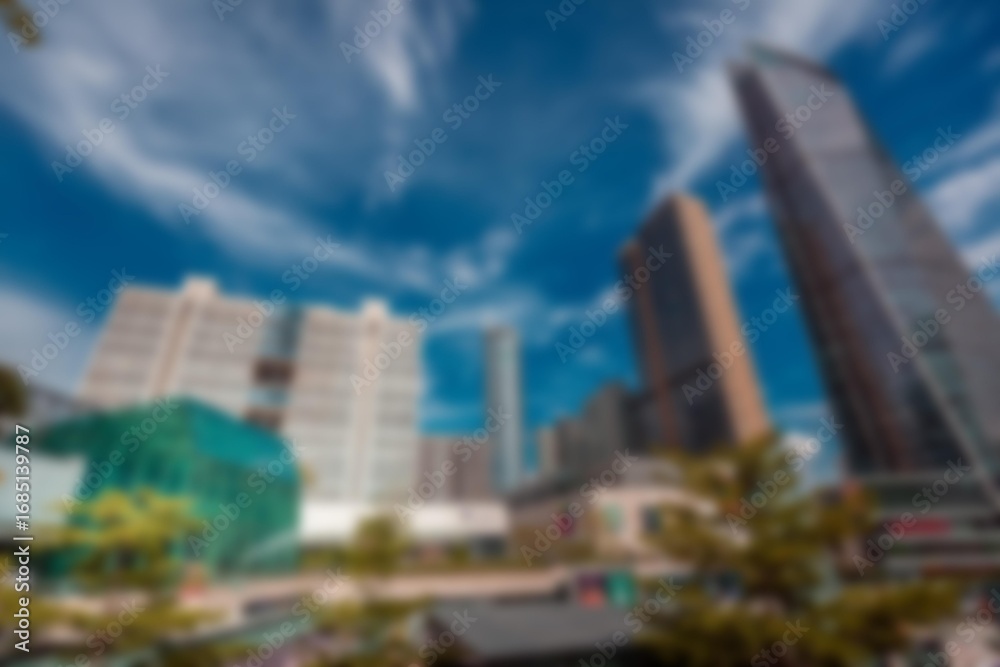 Fototapeta premium An abstract view of a modern cityscape with tall buildings and a blue sky.