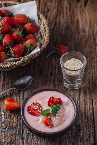 Fresh Yogurt with Strawberries and Oats on Rustic Table