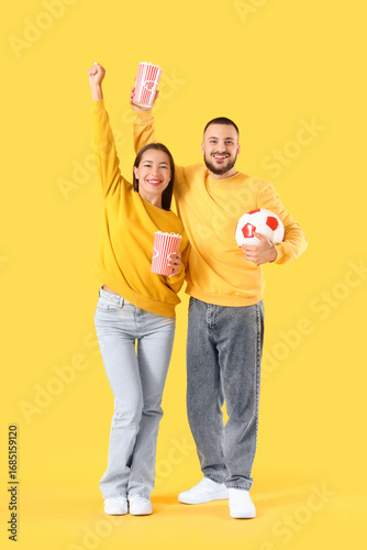 Excited young couple watchi...