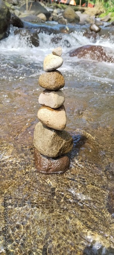 stack of balanced stones in flowing river water