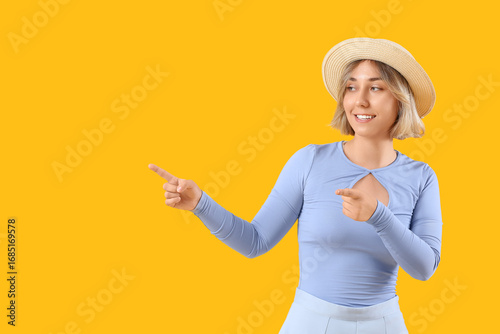 Beautiful woman in hat poin...