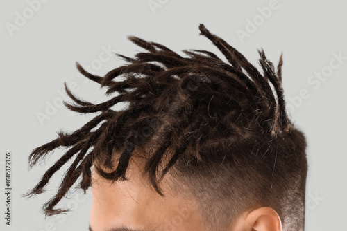 Young man with dreadlocks o...