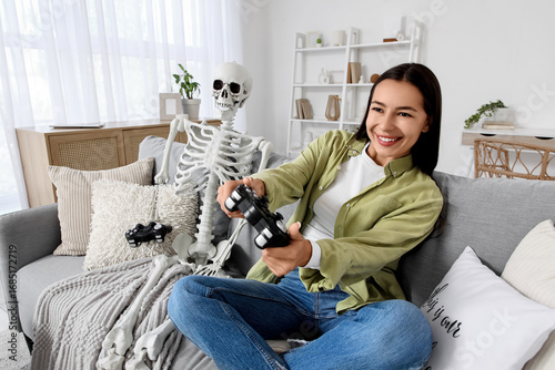 Young woman with human skel...