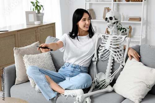 Young woman with human skel...
