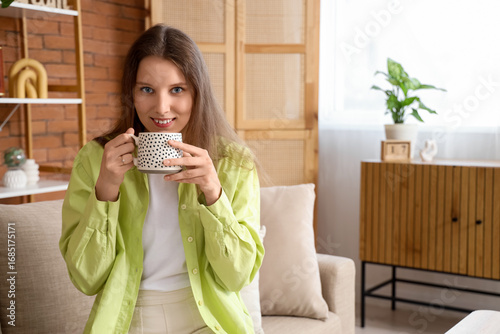 Young woman drinking tea on...