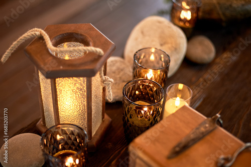 Handmade wooden lanterns and large stones in the d cor of the wedding table in the style of Vikings and warriors. Tree.