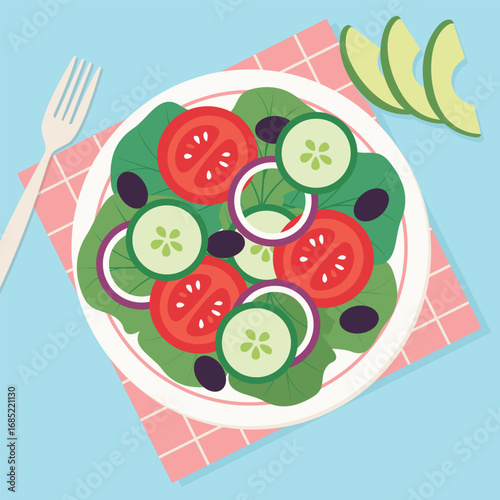 Overhead shot of a salad on a white plate placed on a pink checkered napkin with a fork to the left and avocado slices