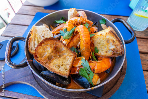 buzara traditional seafood dish in Croatia with shrimp mussels and red sauce