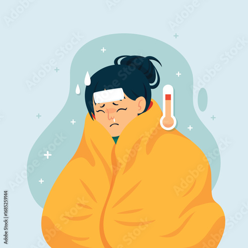 Unwell woman with a high fever wrapped in a blanket