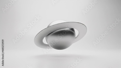 Metallic orb with a ring floating on a soft white backdrop, minimalist abstract art