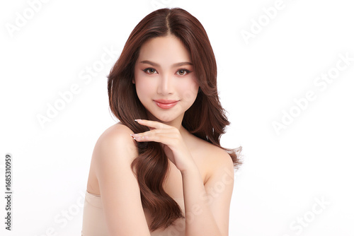 A beautiful young Asian woman with clean, fresh skin against a white background. Skincare, facial treatment, cosmetology, beauty, and spa. An elegant portrait of an Asian woman.