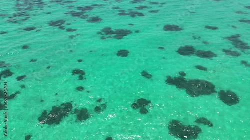 drone flight over clear and blue sea