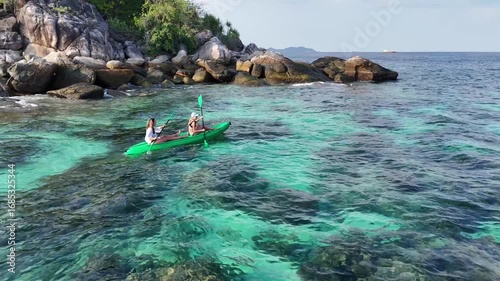two girls on a kayak in the clear sea