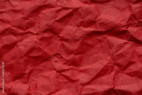 Close-up macro of wrinkled red paper texture,Red crumpled paper macro,dark red background of crumpled paper, free space for text.