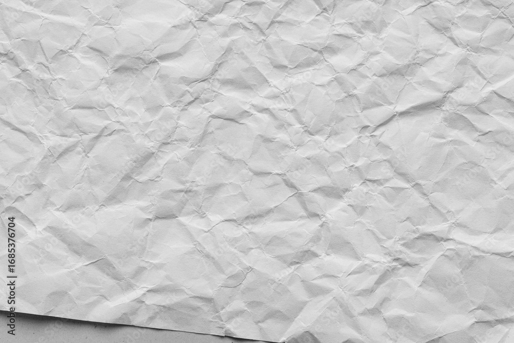 Fototapeta premium Close-up macro of crumpled white paper texture,Wrinkled and crumpled white paper texture. Perfect as a background for design, art, and creative projects.
