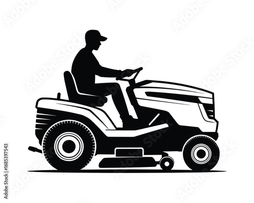 Silhouette of a person driving a riding lawn mower