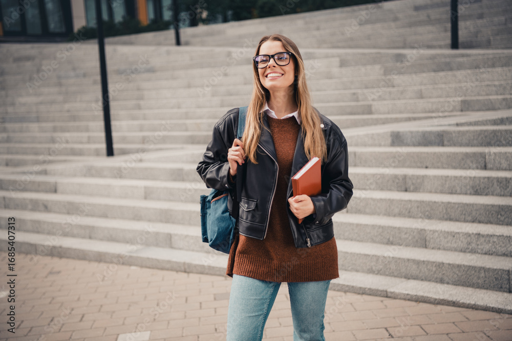 Fototapeta premium Stylish young woman enjoying an outdoor city walk with casual fashion - vibrant lifestyle in urban environment