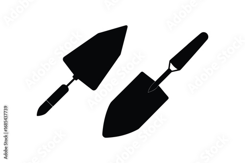 Two black silhouettes of trowels with handles on a white background