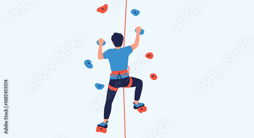 Man climbing up artificial rock wall with blue and red holds and safety rope
