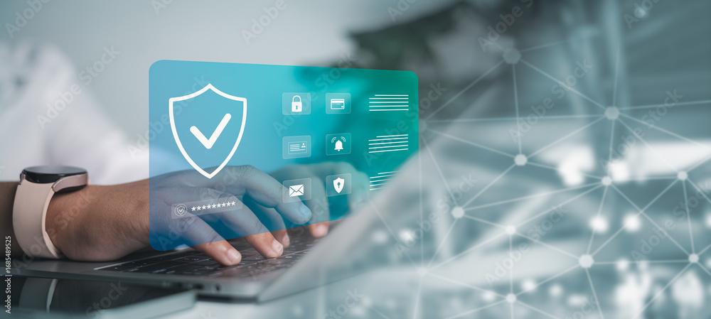 Person is typing on a laptop with a prominent digital security shield ...