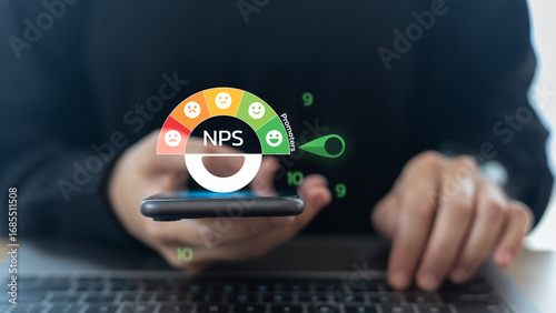 Foto Businessman using a smartphone with the NPS Net Promoter Score gauge dashboard