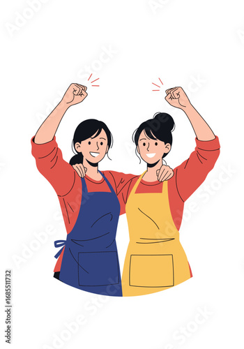 Two smiling women wearing aprons are celebrating with their arms raised in the air
