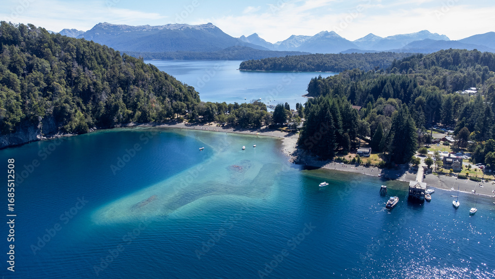 Obraz premium An aerial view of a stunning bay with clear blue-green water and a secluded beach near Villa La Angostura, Argentina. A beautiful Patagonian travel destination