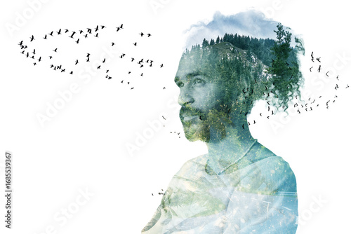 Double exposure portrait of calm man with curly hair blended with forest and flying birds.