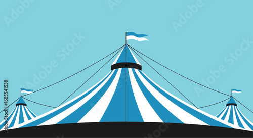 A classic blue and white striped circus tent under a clear sky