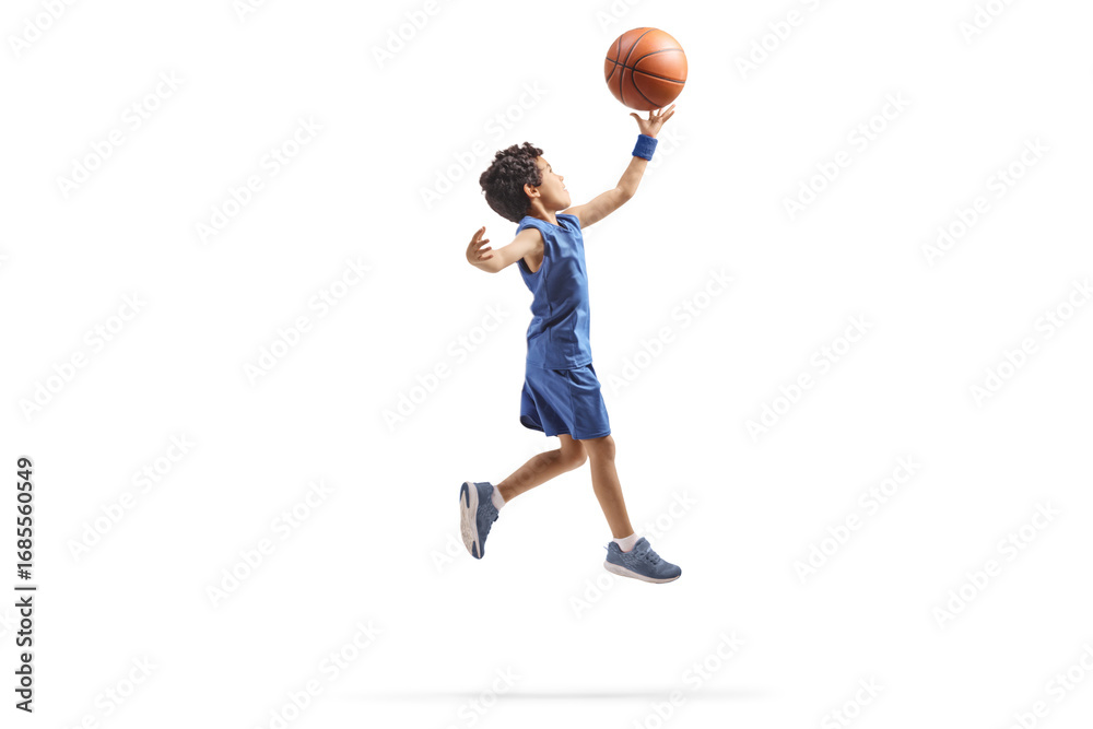 Fototapeta premium Kid jumping with a basketball