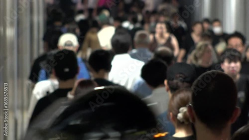 Wallpaper Mural TOKYO, JAPAN - AUG 2025 : Crowd of people walking at the street near the station in busy rush hour at night. Japanese people, urban city life and lifestyle concept 4K video. Torontodigital.ca