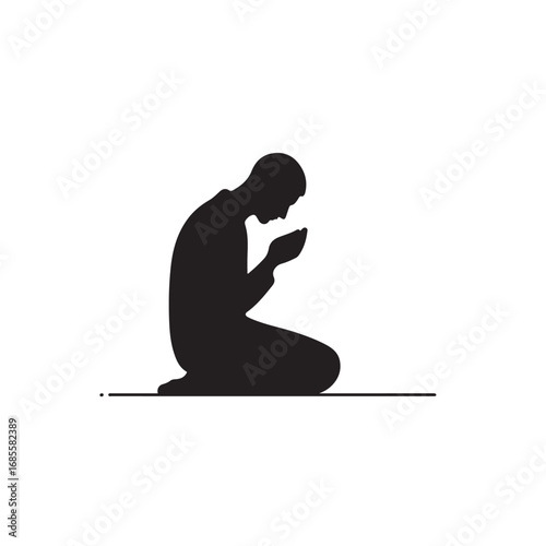 Man performing islamic prayer in a dark silhouette