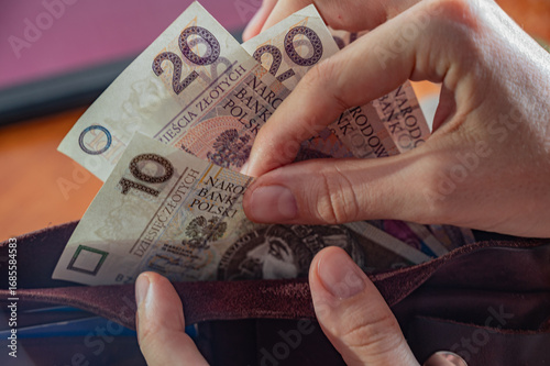 Polish zloty banknotes neatly placed inside a brown leather wallet. Concept for finance, money management, savings, banking, or personal budget.