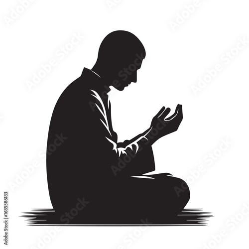 Man performing islamic prayer in a dark silhouette