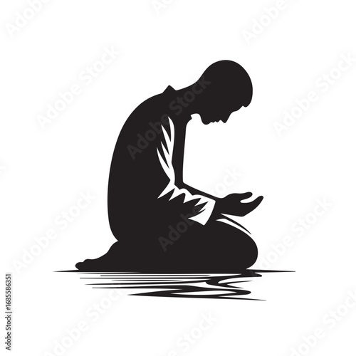 Man performing islamic prayer in a dark silhouette